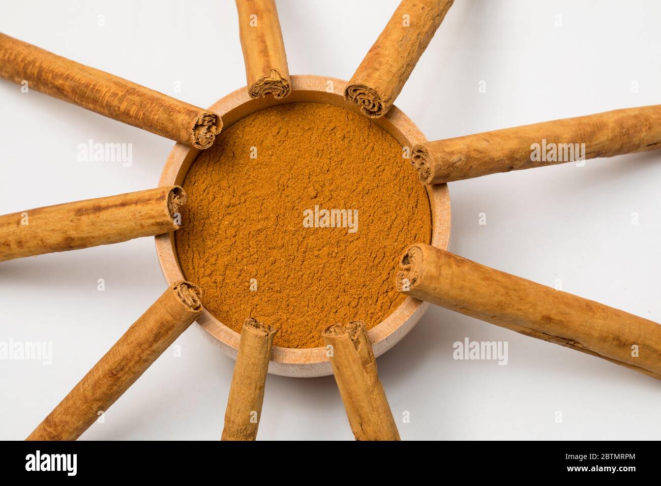Close-up view of cinnamon sticks and powder on white background. Stock Photo