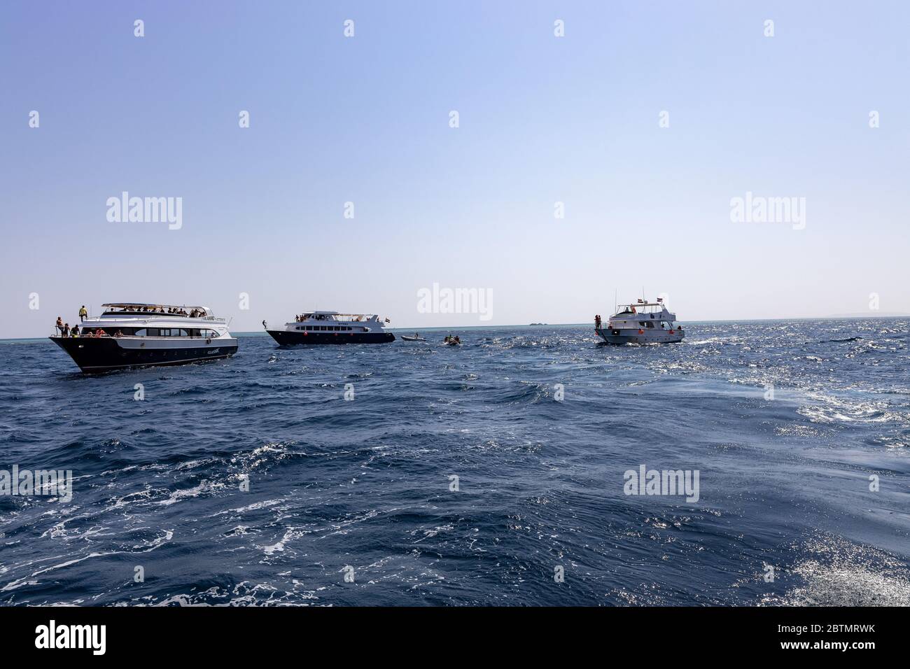Hurghada, Egypt - september 17, 2019: Unknown people on white yacht watching dolphins in the Red sea, Jaz 'ir Jift n Stock Photo