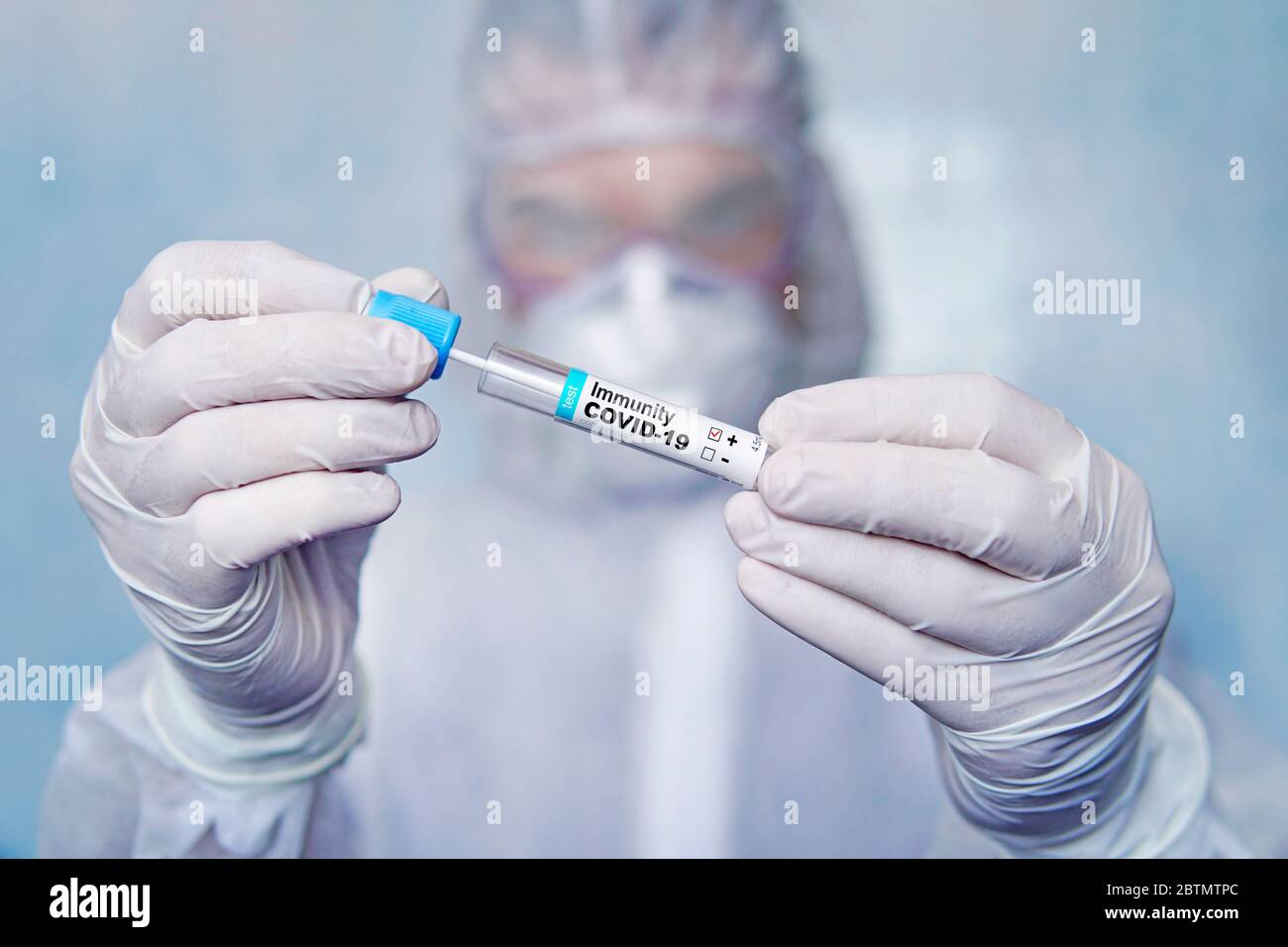 positive test for antibodies to coronavirus. Checking the population for immunity to covid 19. test tube with a blood test in the hands of a doctor Stock Photo