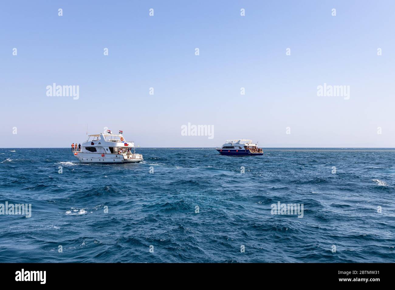 Hurghada, Egypt - september 17, 2019: Unknown people on white yacht watching dolphins in the Red sea, Jaz 'ir Jift n Stock Photo