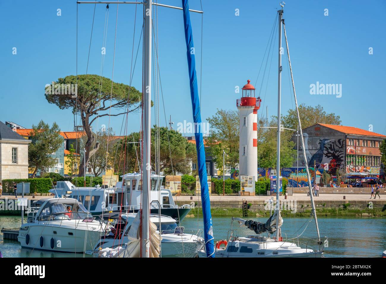 Red lighthouse and sailboats in the old harbor of La rochelle, France Stock Photo