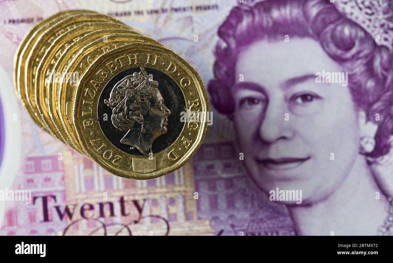 One pound coins on the new polymer £20 banknote Stock Photo