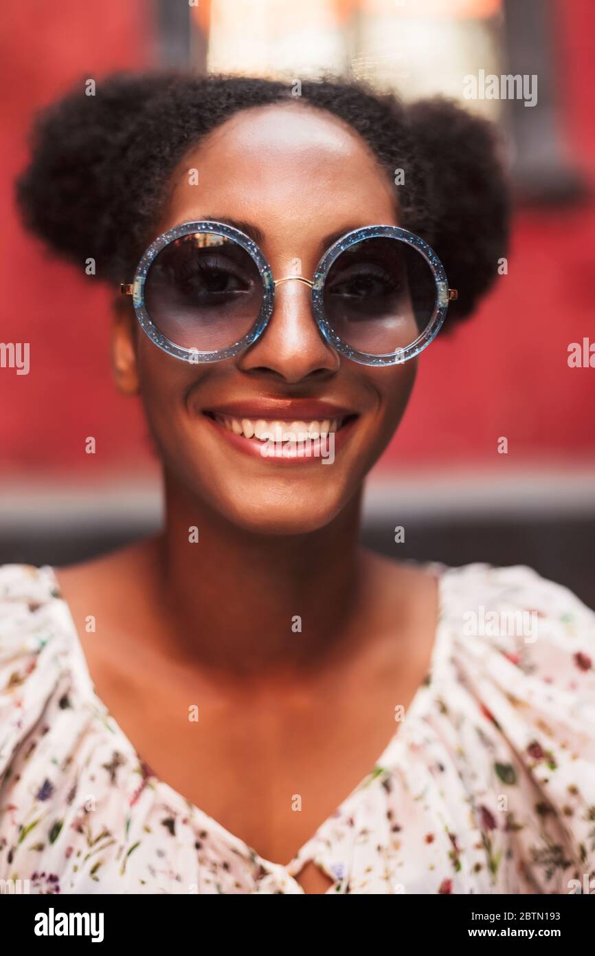 Portrait of beautiful smiling african girl with dark curly hair in ...