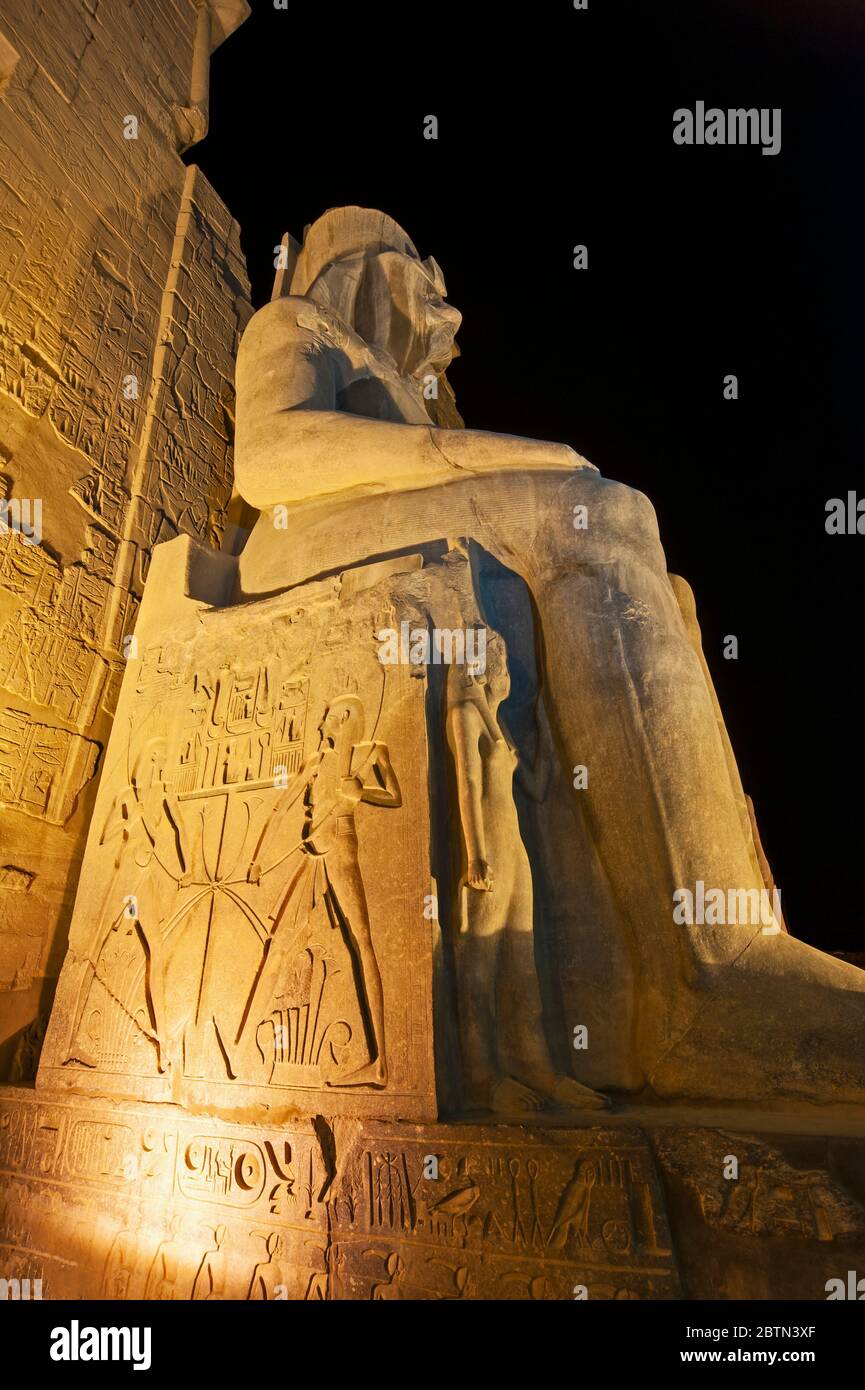 Large statue and hieroglypic carvings of Ramses II at the ancient ...