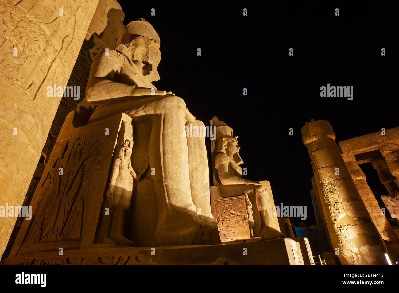 Large statue and hieroglypic carvings of Ramses II at the ancient ...