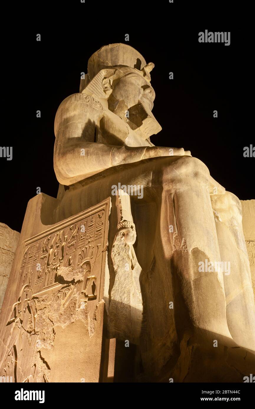 Large statue and hieroglypic carvings of Ramses II at the ancient ...