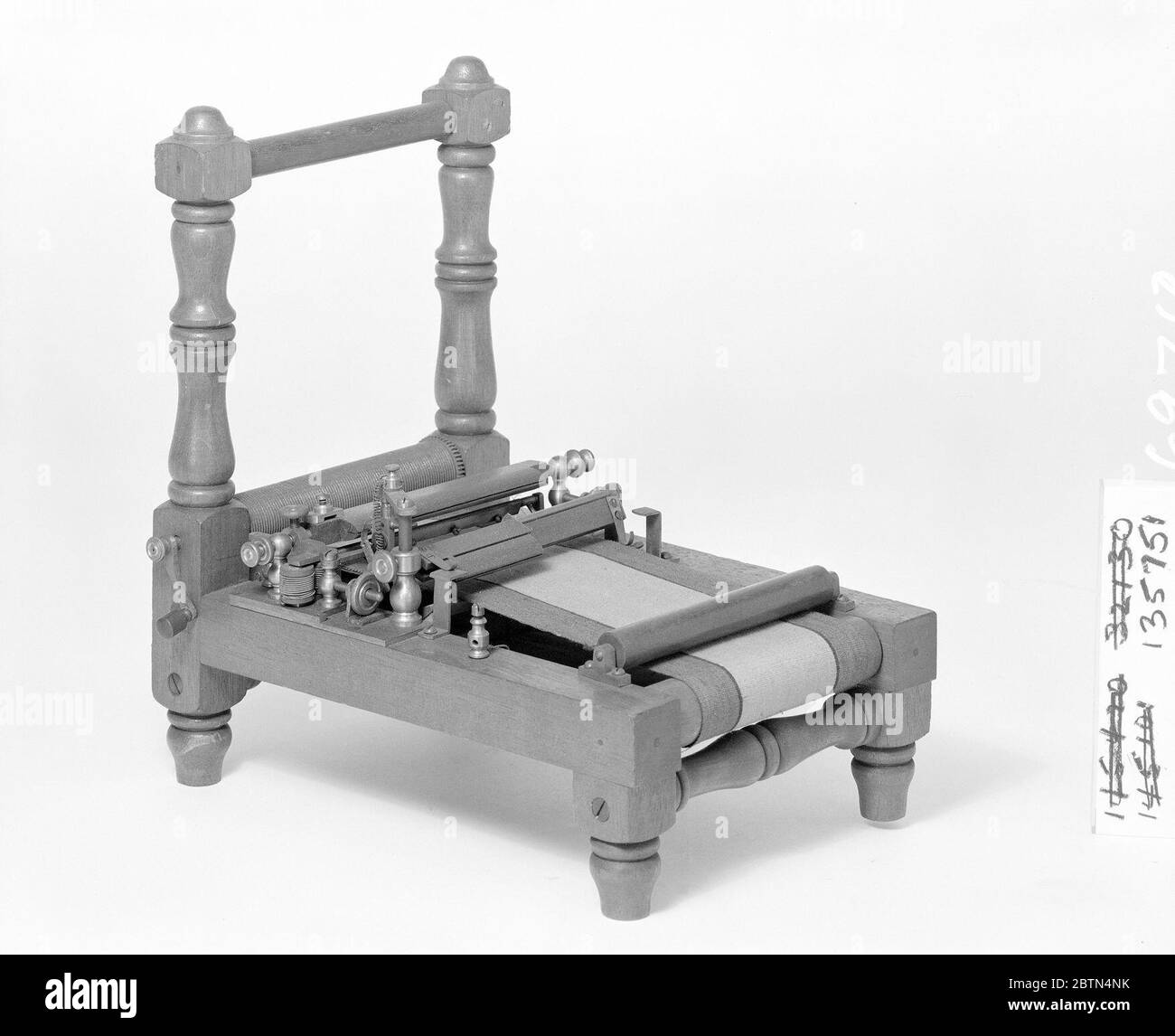 Patent Model for a Paperruling Machine. This patent model demonstrates an invention for a paper-ruling machine which was granted patent number 135751. The ruling pens on the machine were lowered and lifted by an electro-magnetic apparatus, a 'quick and lively but soft and easy' action. Stock Photo