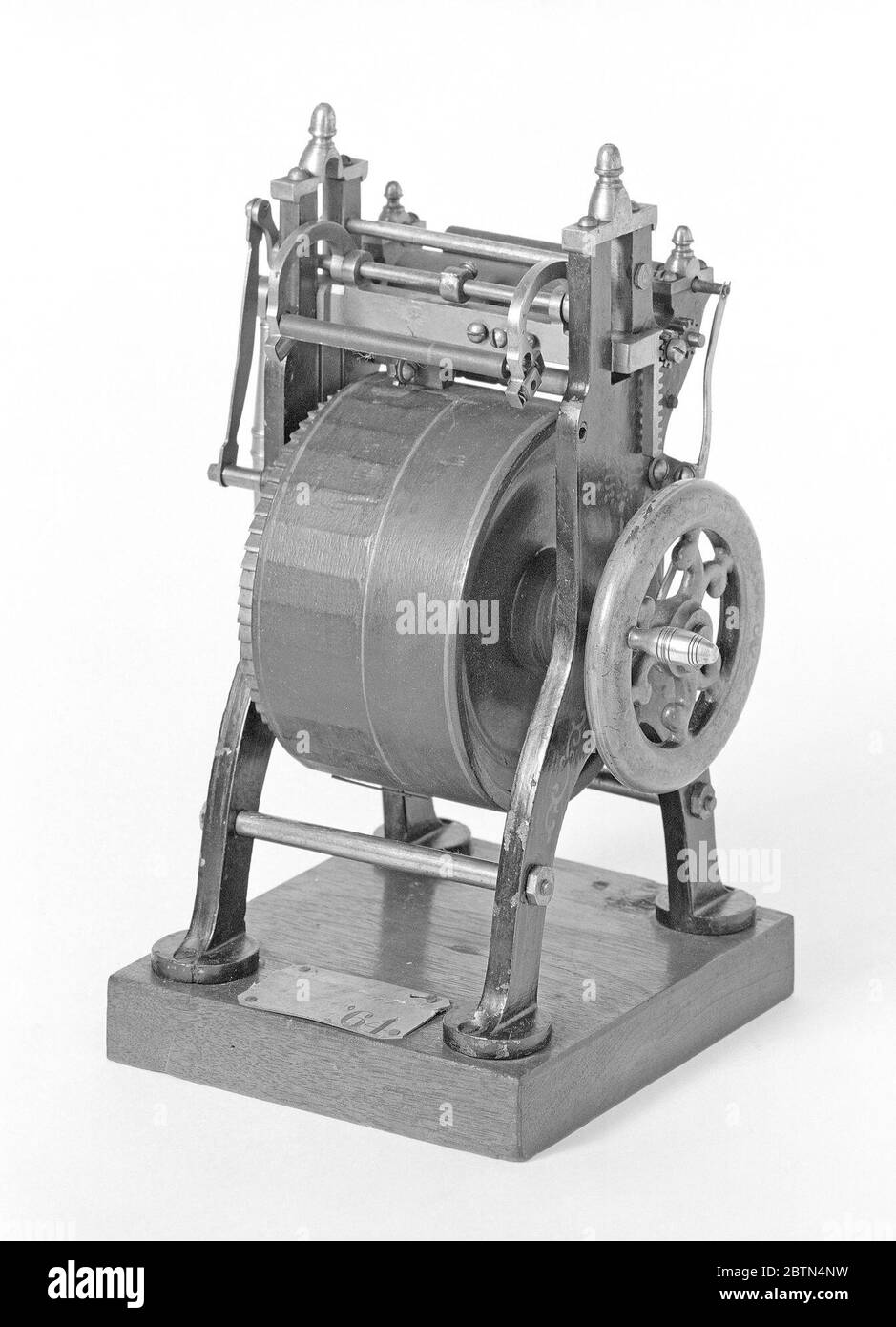 Patent Model of a Press for Card and Ticket Printing. This patent model demonstrates an invention for a card and ticket press which was granted patent number 48493. The patent details a self-inking press in which a series of flattened surfaces on a large rotating drum provided multiple platens. Stock Photo
