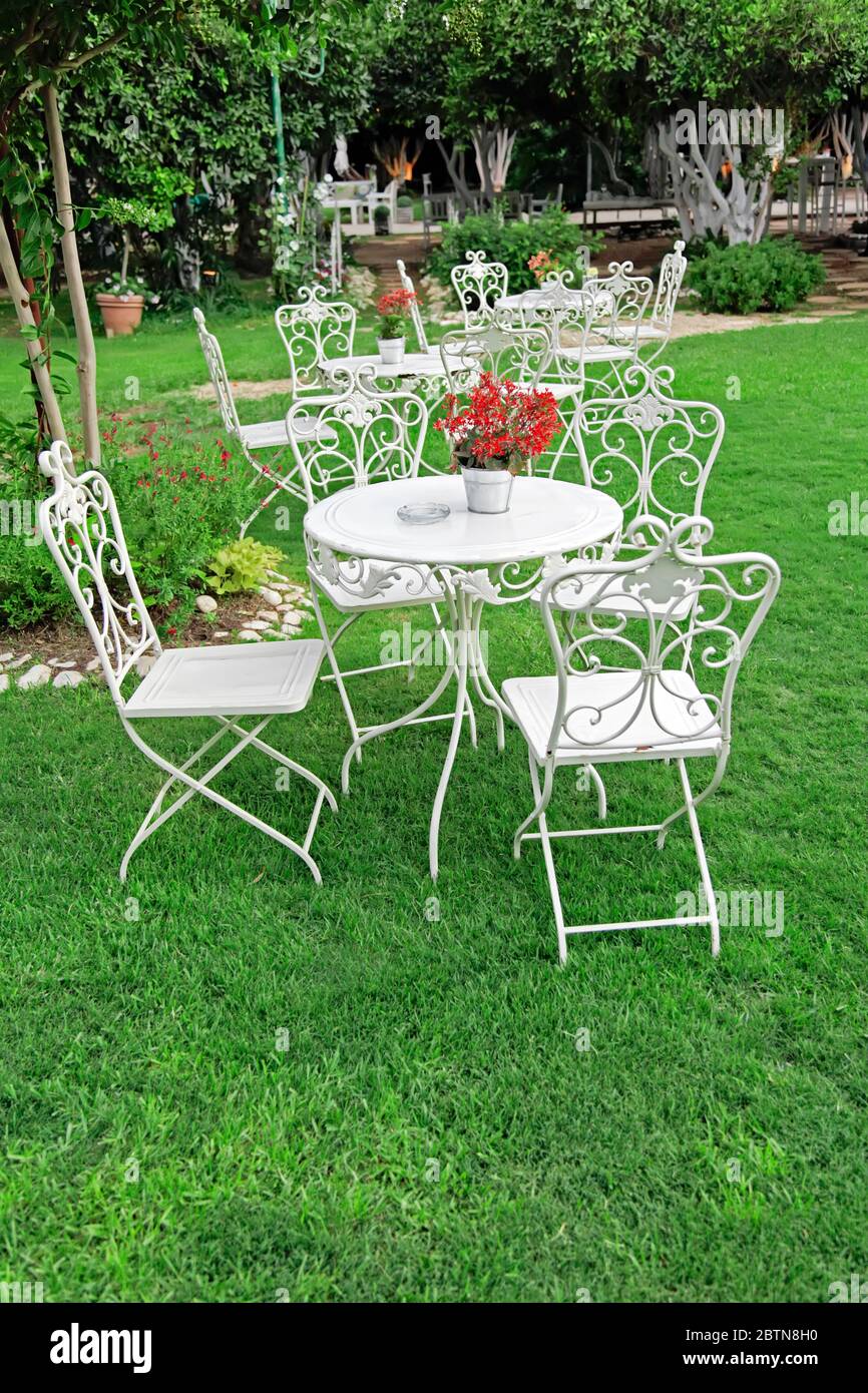 White garden furniture in beautiful garden. Vintage garden outdoor Stock  Photo - Alamy