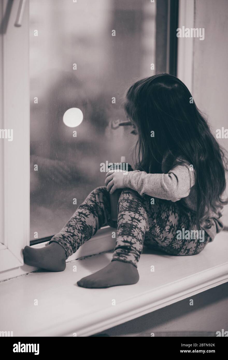 little girl drawing on window glass at home Stock Photo - Alamy