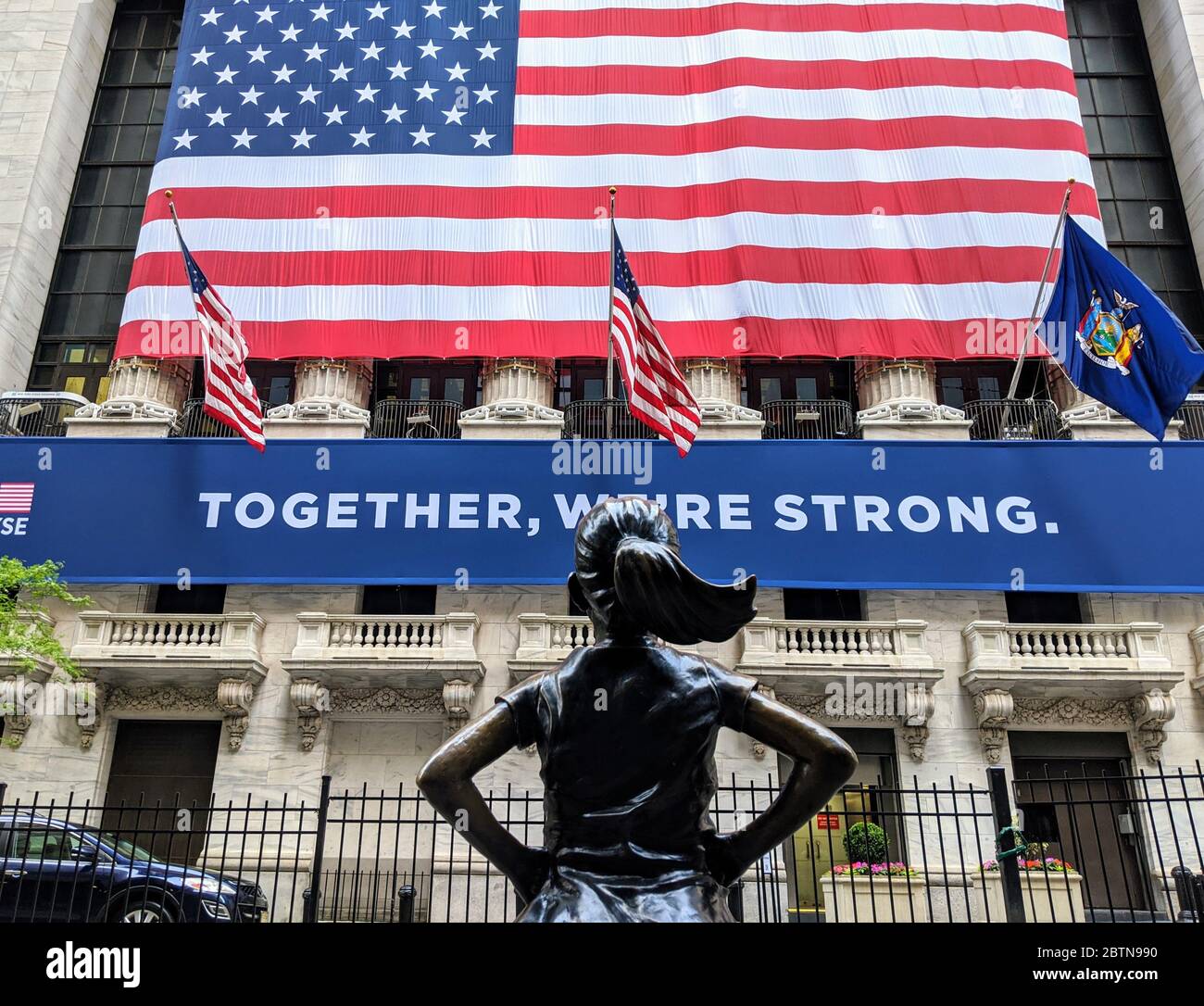 New York Stock Exchange Building and the Fearless Girl Statue as the trading floor reopens after being closed indefinitely during the coronavirus pandemic. Stock Photo