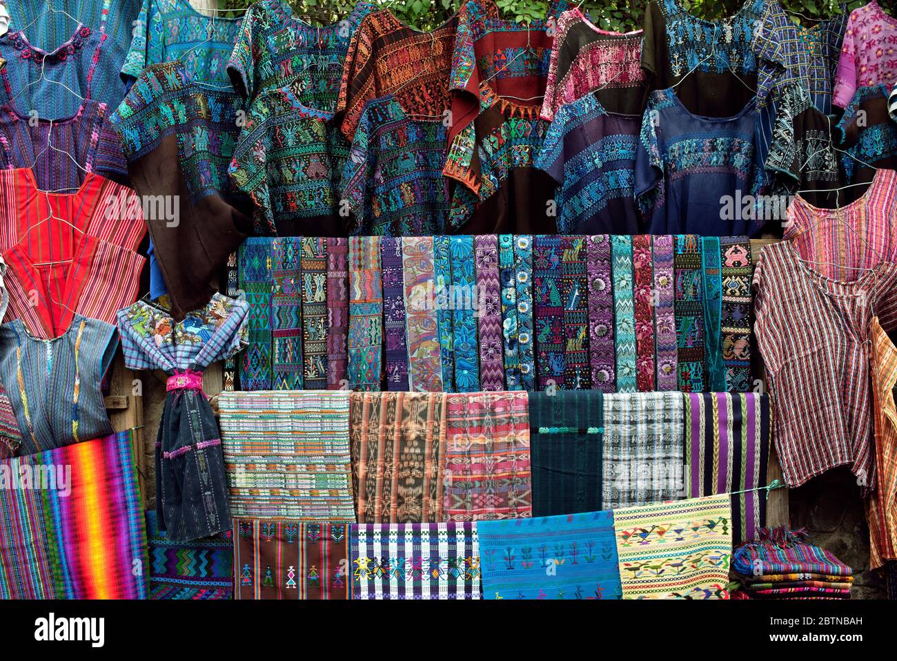 Bright coloured huipil (blouse), faja (belt) and multicoloured handwoven Guatemalan textiles for sale. Santa Catarina Palopó, Lake Atitlán, Guatemala Stock Photo