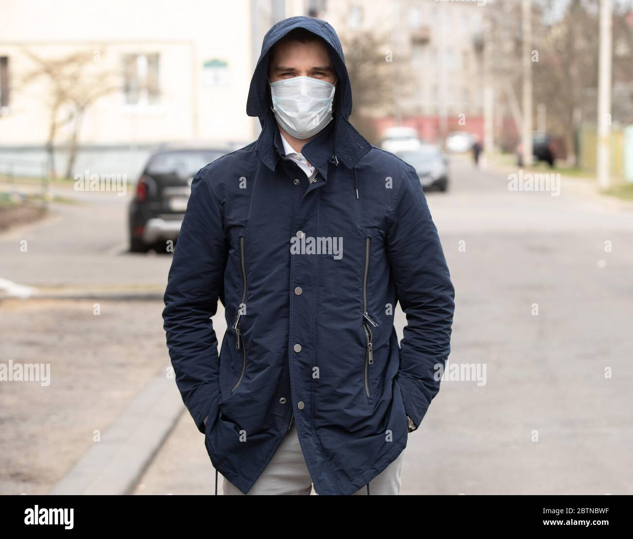 Pandemic, portrait of a young man wearing protective mask on street ...