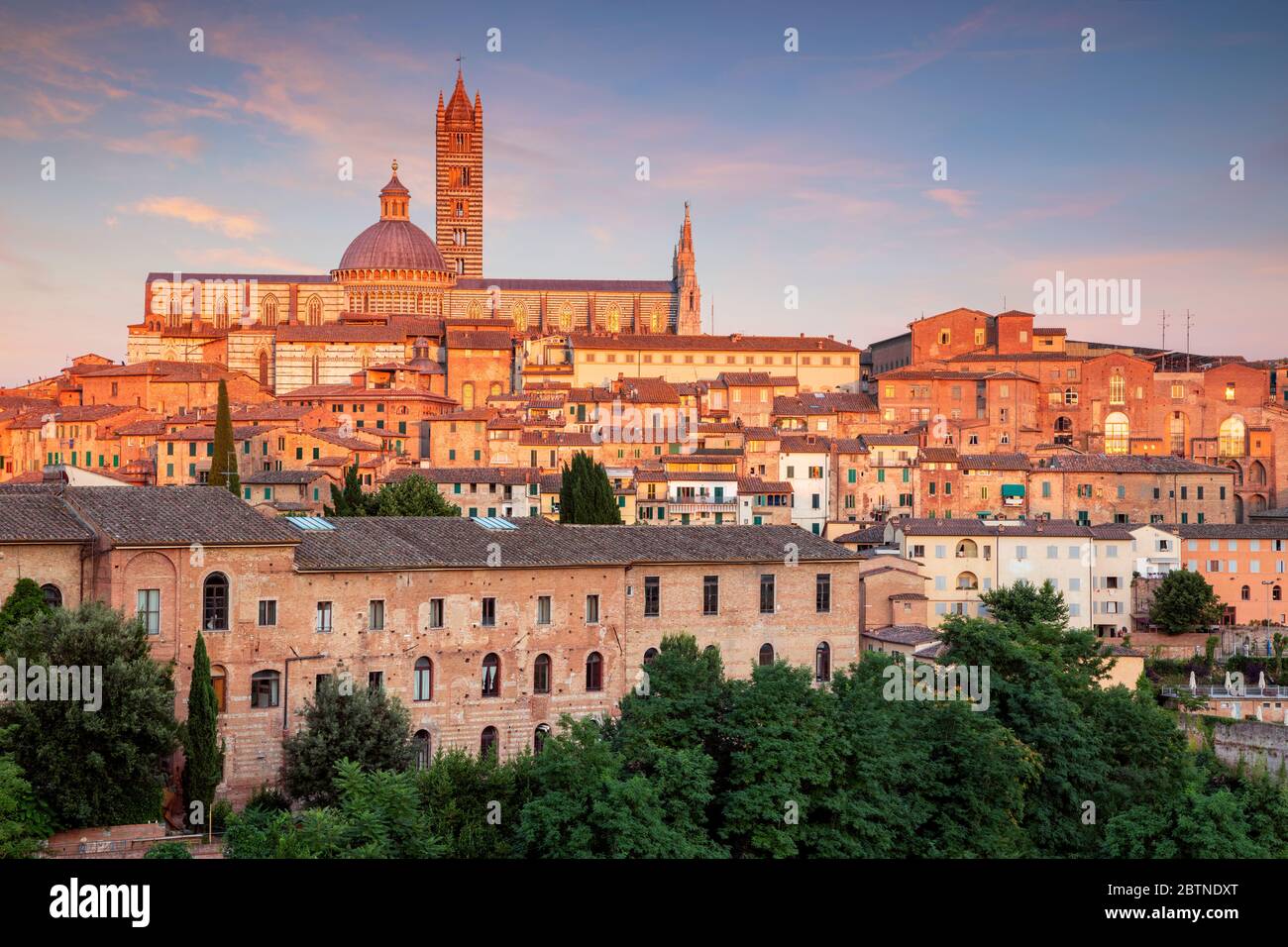 Siena. Aerial cityscape image of medieval city of Siena, Italy during sunset. Stock Photo