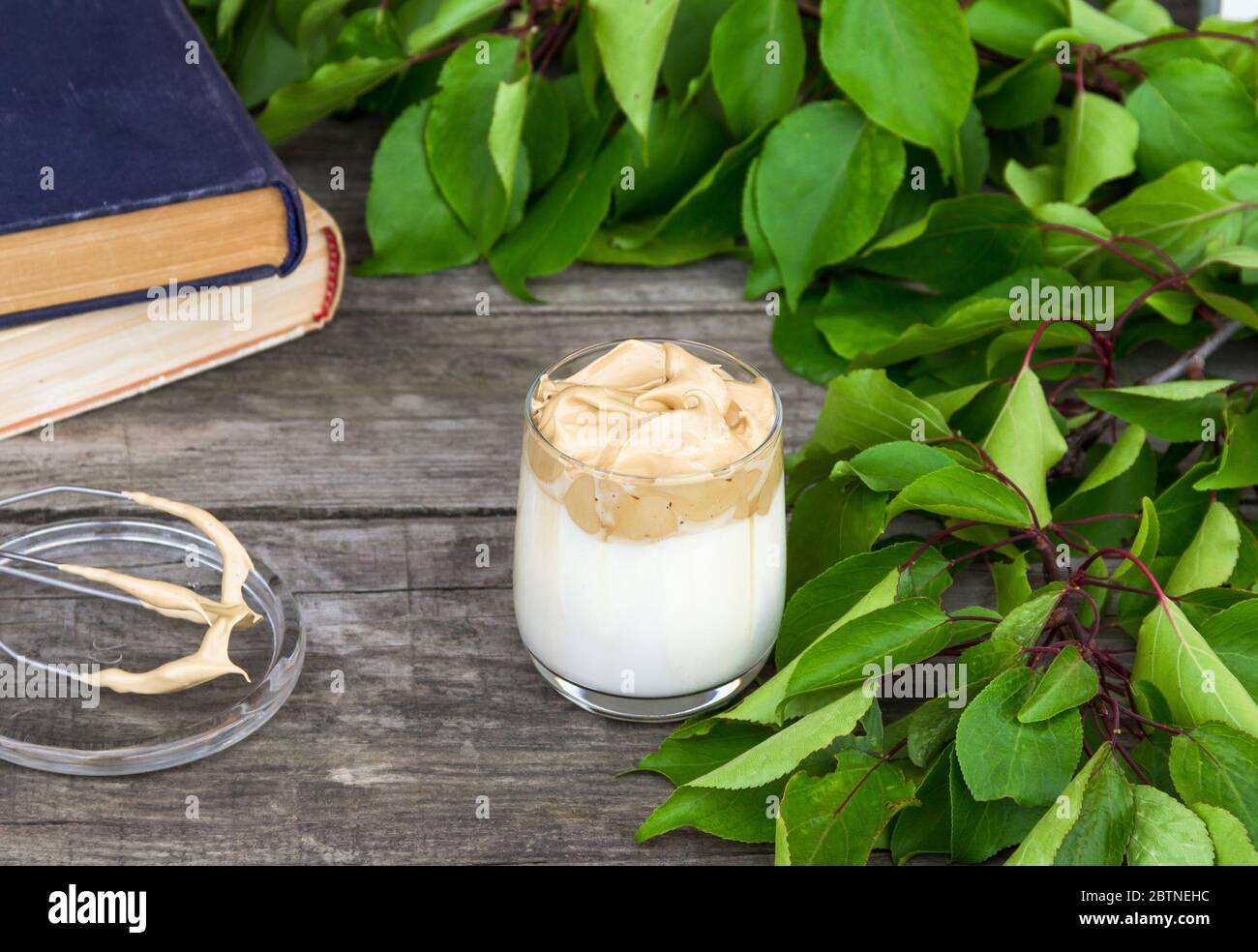 Dalgona coffee on wooden rustic background. Stock Photo