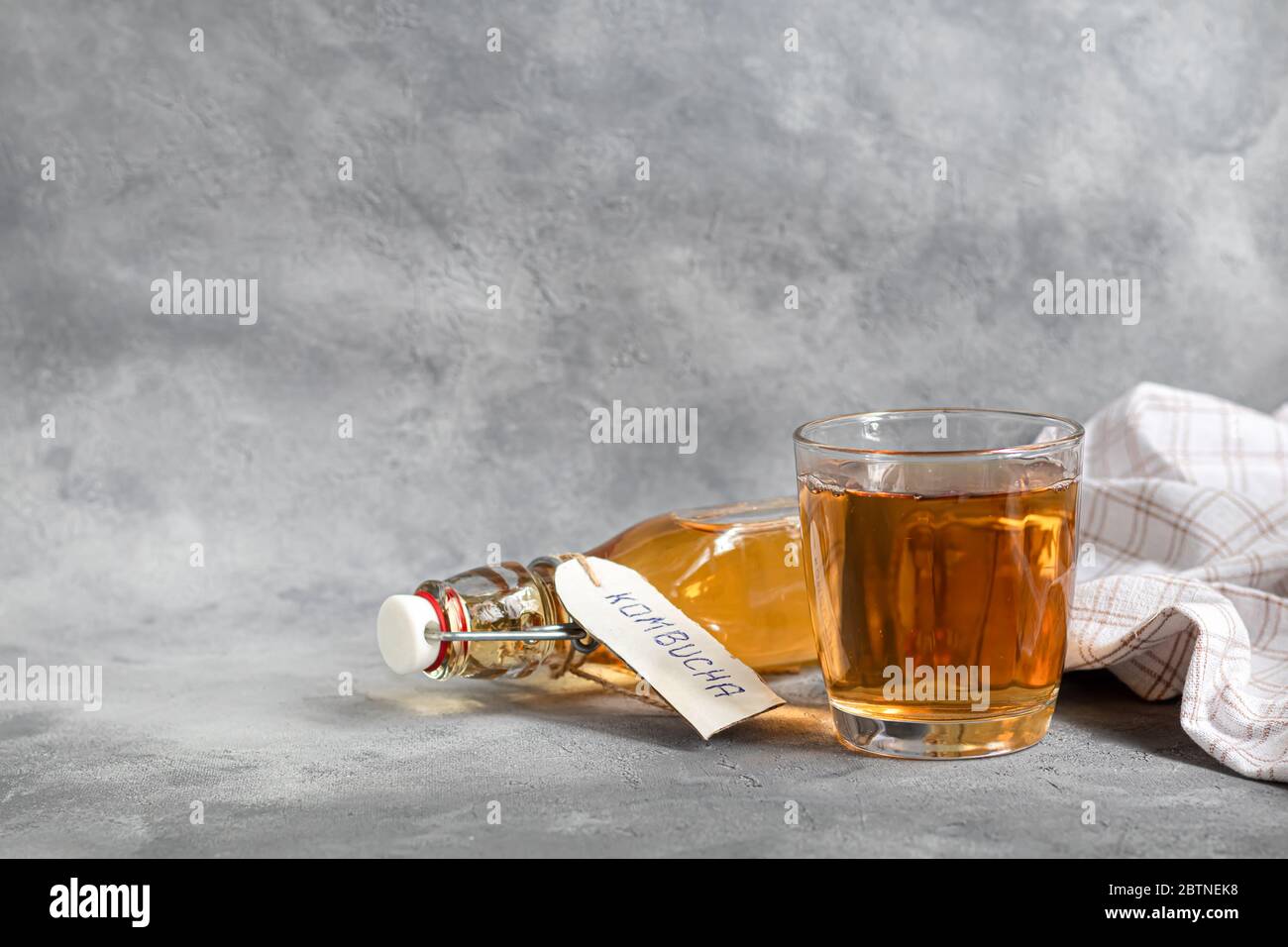 Kombucha or cider, fermented drink on a gray background. A probiotic