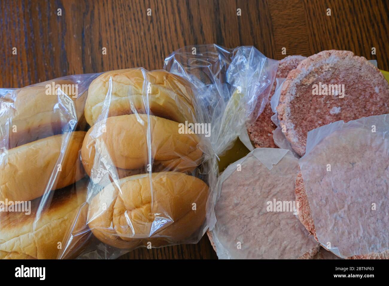 Frozen Raw Beef Burger Patties prepared for Barbeque Grill Stock Photo