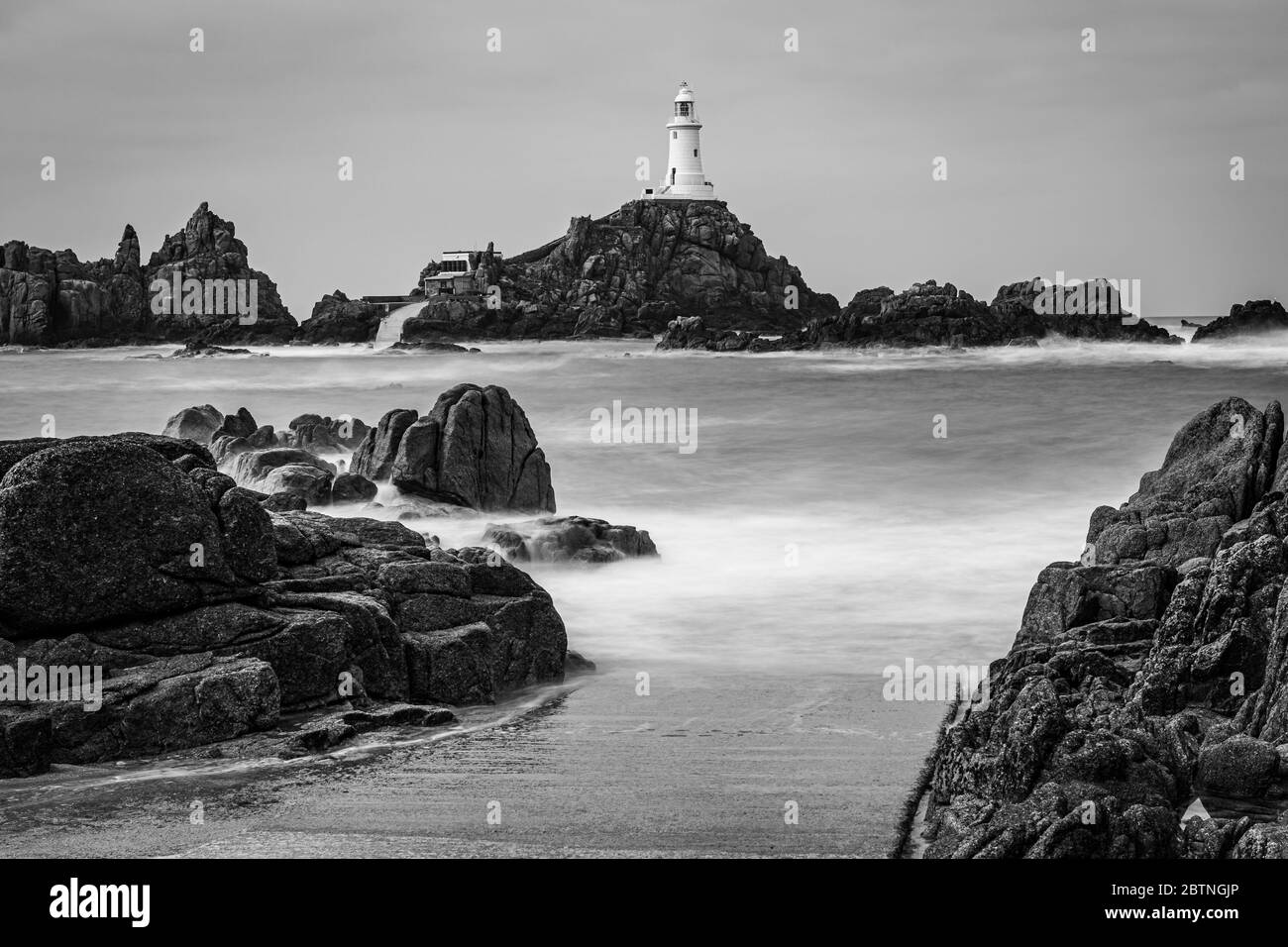 High tide covers the causeway leading to La Corbiere lighthouse, Jersey, Channel Islands, UK Stock Photo