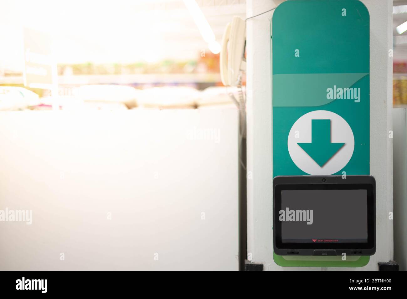 The barcode price scanner on the wall in a supermarket for self service