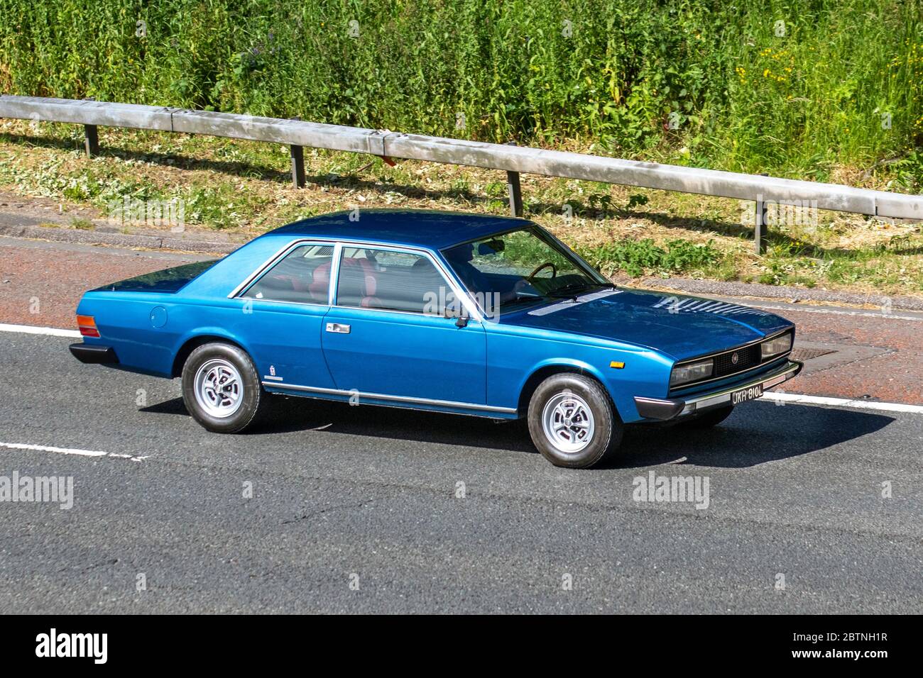 1972 Blue Fiat 130; Vehicular traffic moving vehicles, classic cars, cherished, veteran, old timer, restored, collectible, motors, vintage, heritage, old preserved, collectable cars driving vehicle on UK roads, motoring on the M6 motorway highway Stock Photo