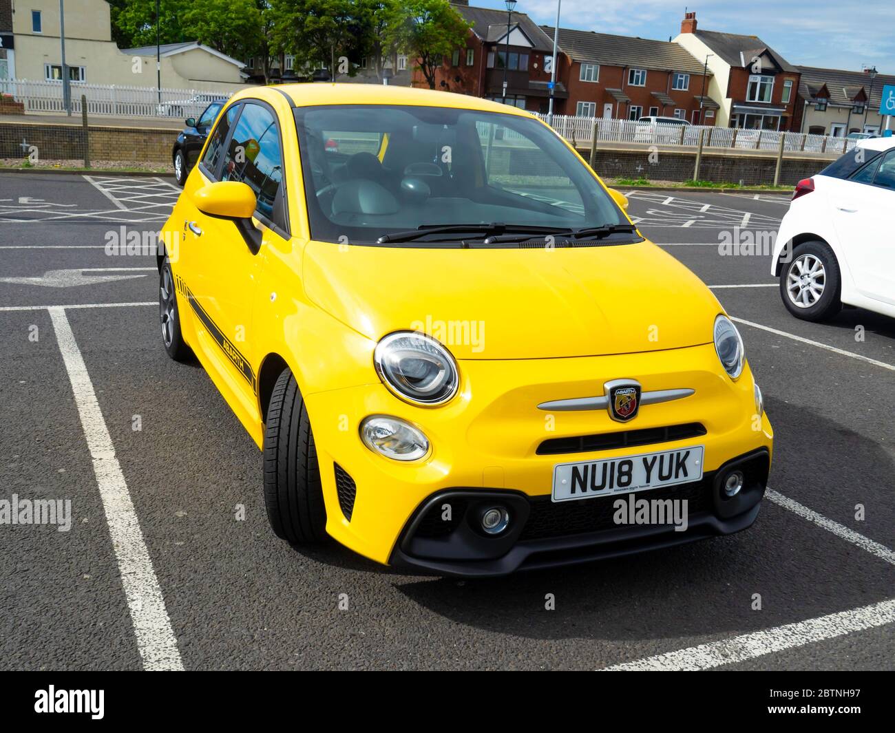 A 2018 registered bright yellow Fiat 500 Abarth spots car in Saltburn North Yorkshire Stock Photo