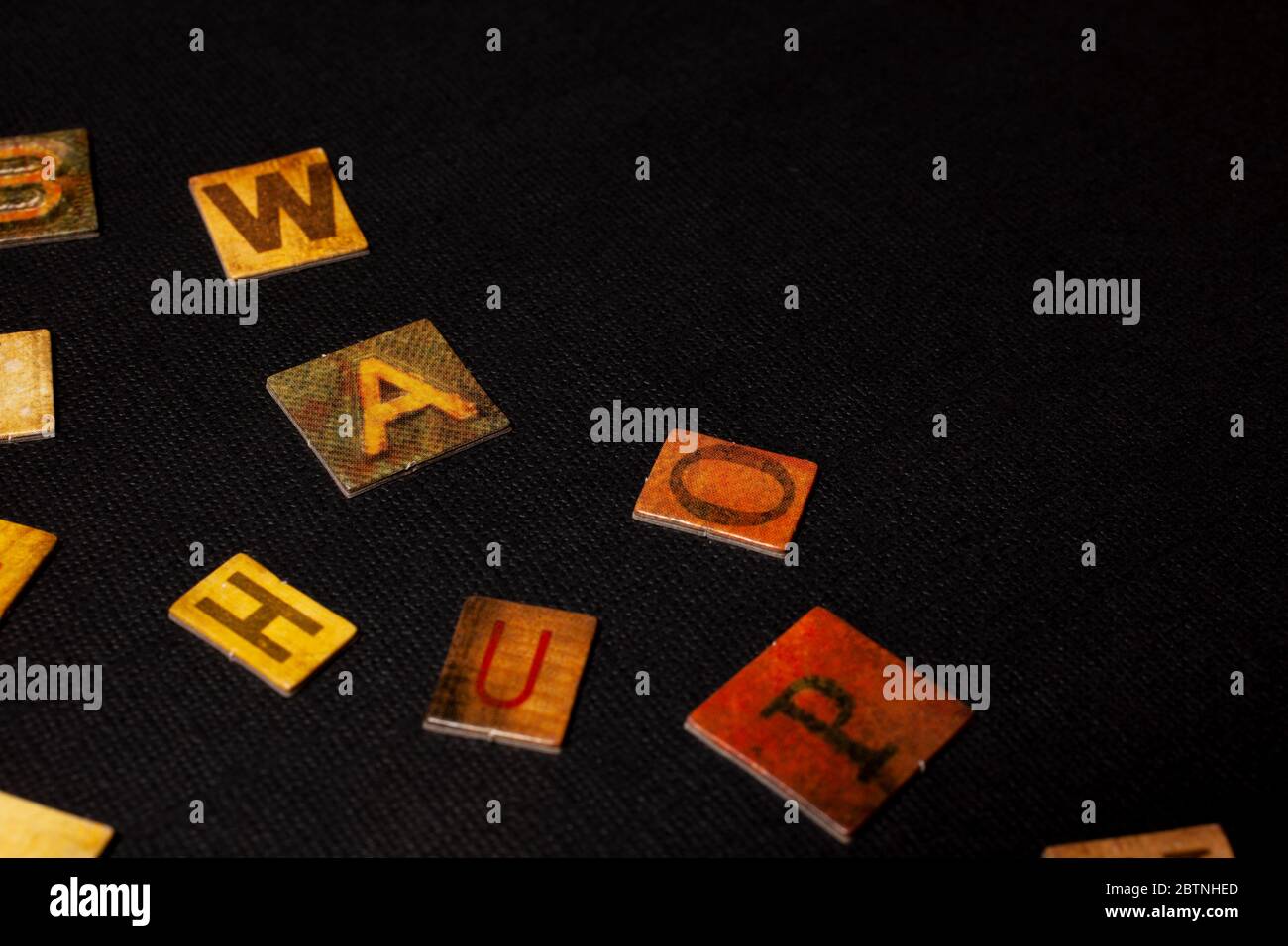 random letters of alphabet on black background Stock Photo