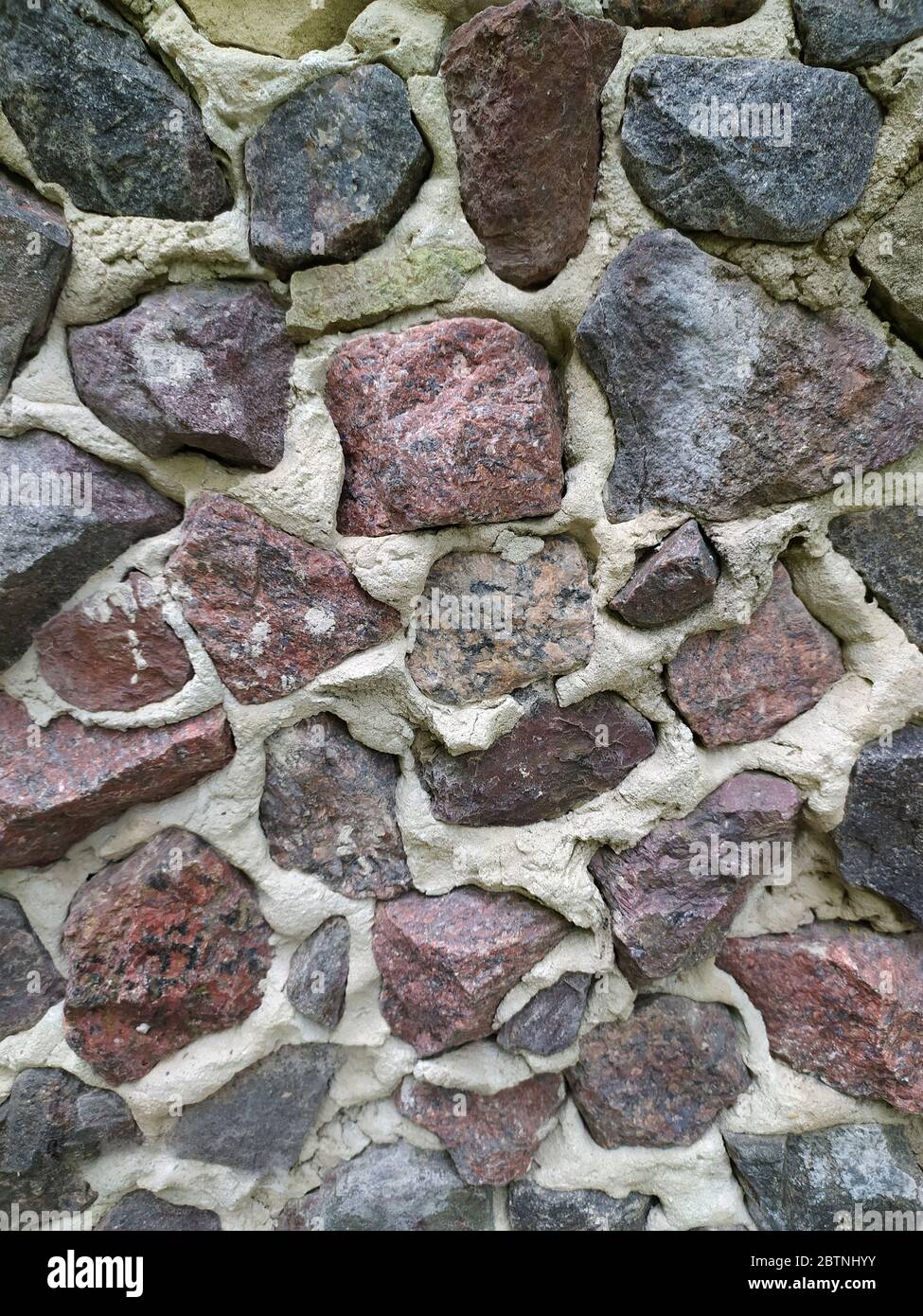 Gray, brown, black stone wall background, granite mosaic stonewall