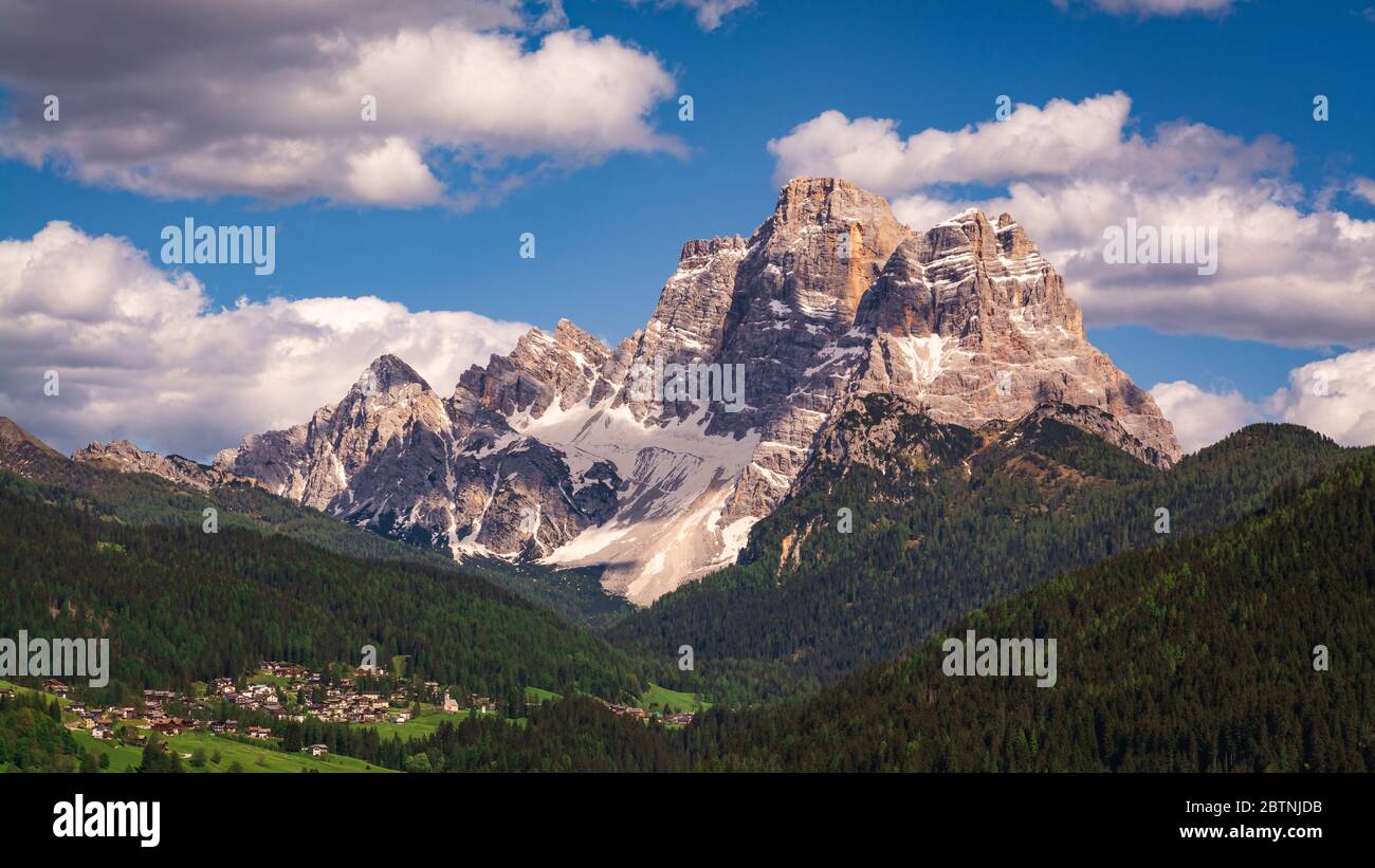 Scenic view of Pelmo Mountain (italian dolomites) against blue sky, with the town of Selva di Cadore in the Fiorentina Valley (Italy, Veneto region) Stock Photo