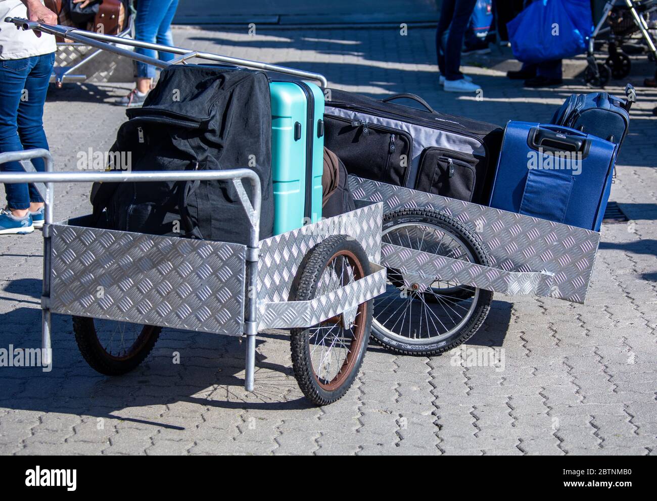 Vitte, Germany. 25th May, 2020. Holidaymakers load their luggage onto hand carts in front of the ferry "Vitte" in the harbour on the Baltic island of Hiddensee. The first holidaymakers return to the Baltic Sea after the lifting of the Corona travel ban. Credit: Jens Büttner/dpa-Zentralbild/ZB/dpa/Alamy Live News Stock Photo