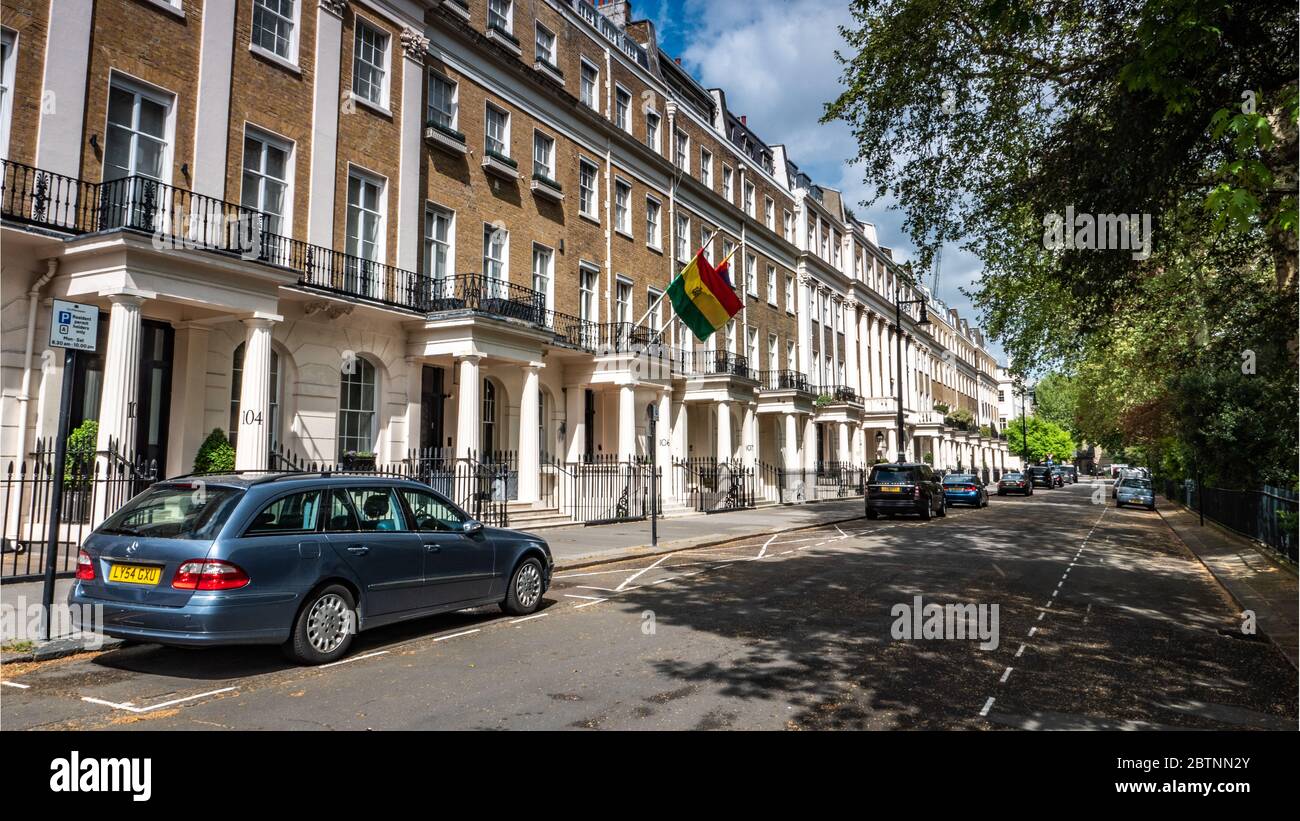 Embassy of Bolivia, London. Georgian terraced houses in Eaton Square, Belgravia, containing The Bolivian Embassy discernible by its national flag. Stock Photo