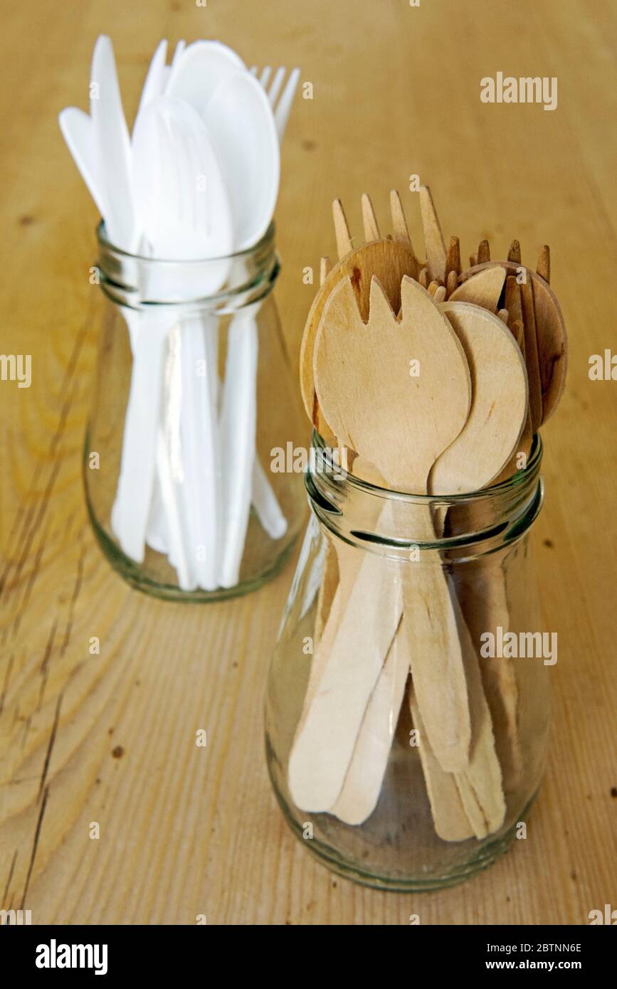 Reused wooden and plastic cutlery in glass jars on table.  No need to throwaway, just wash and reuse.  Zero waste concept Stock Photo