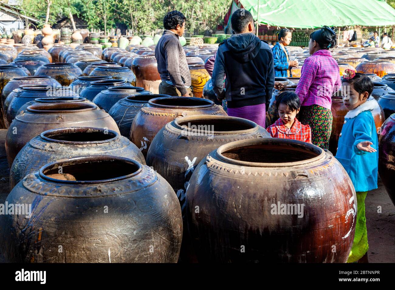 Burmese People Buying Large Storage Pots, Ananda Temple, Bagan, Mandalay Region, Myanmar. Stock Photo