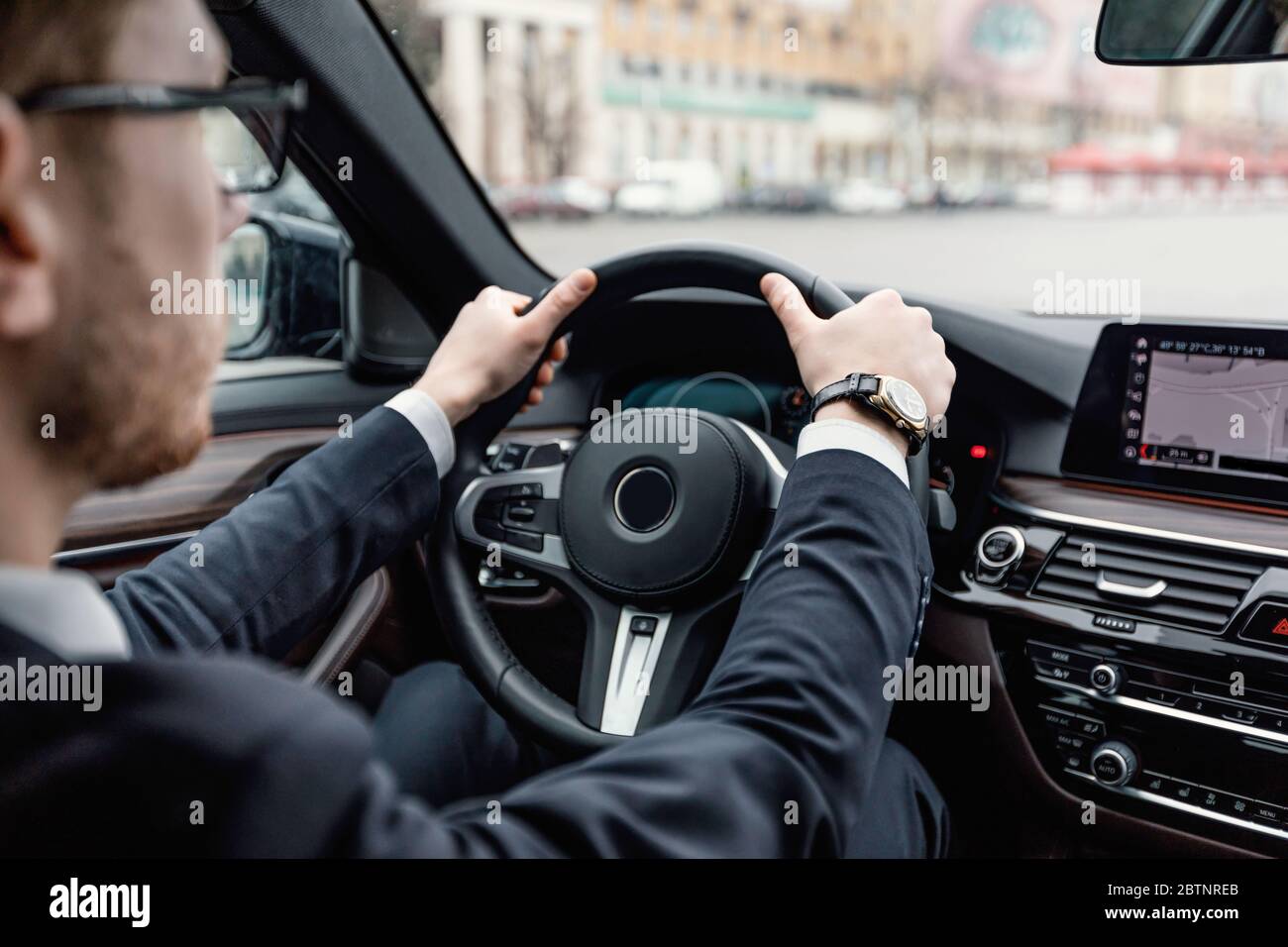 Bearded businessman driving alone in his new car Stock Photo - Alamy