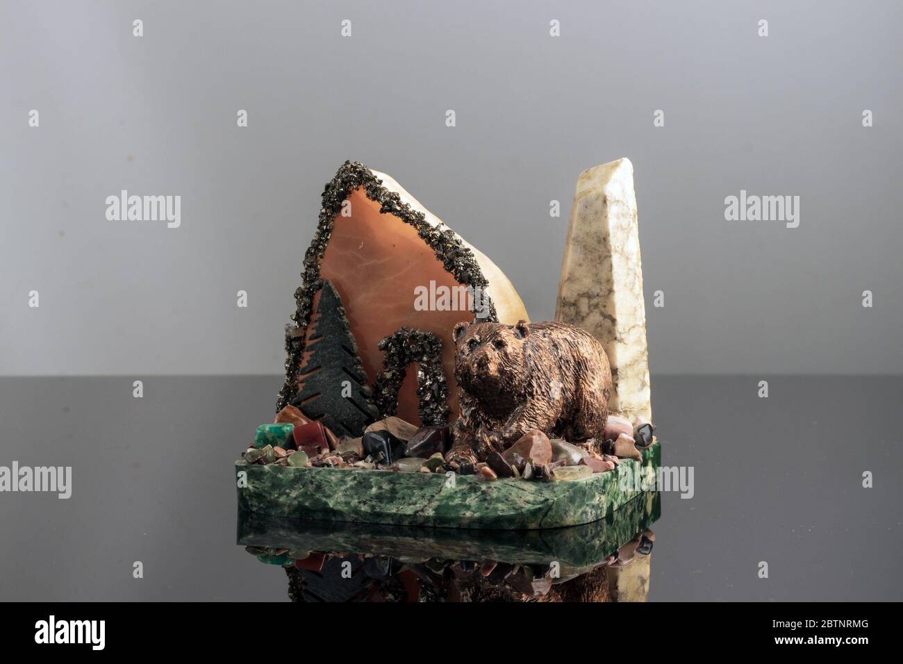 The souvenir of stone and plaster is a mountain, stones and bear. Stock Photo