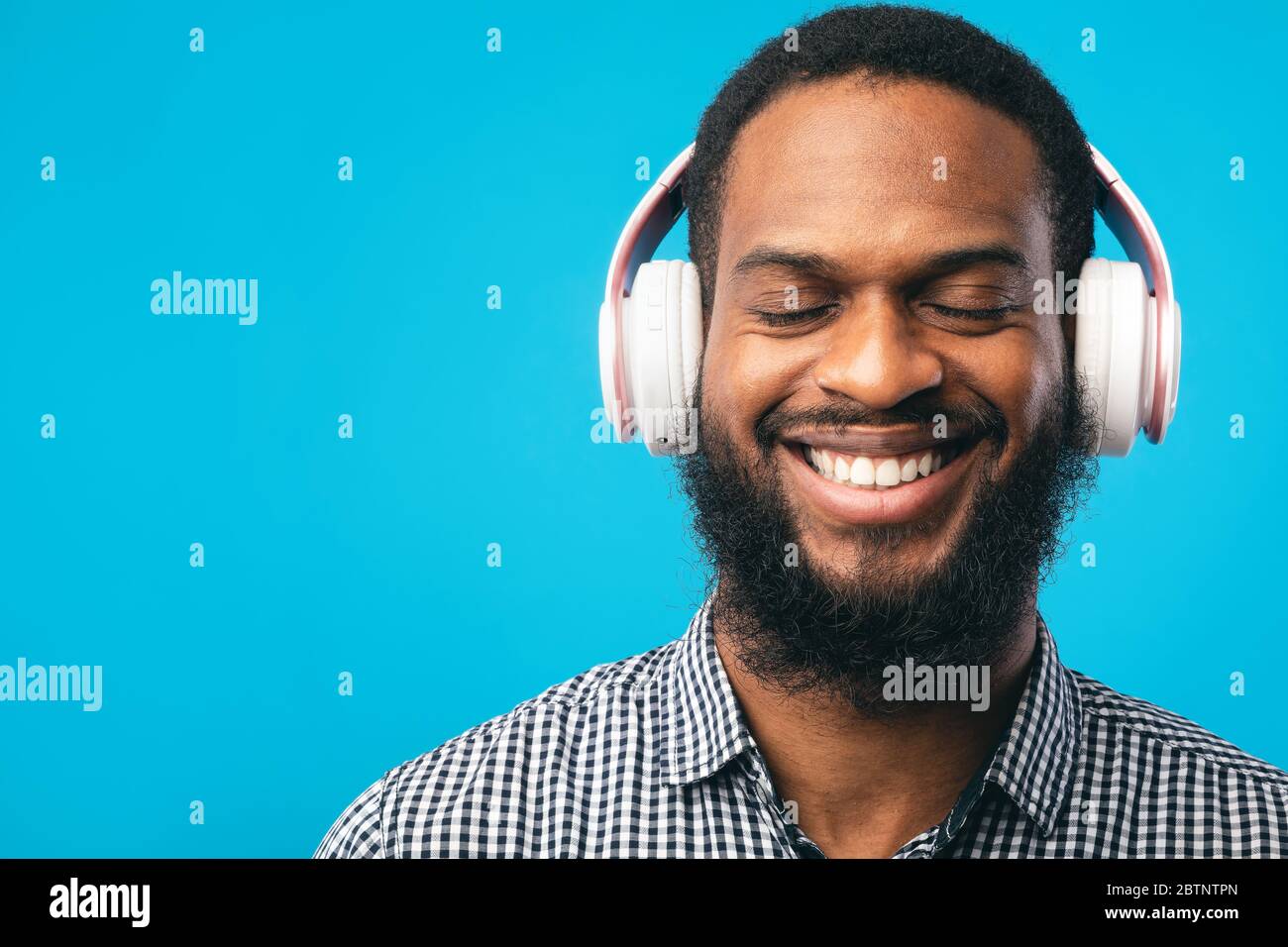 Smiling afro man headphones using hi-res stock photography and images ...