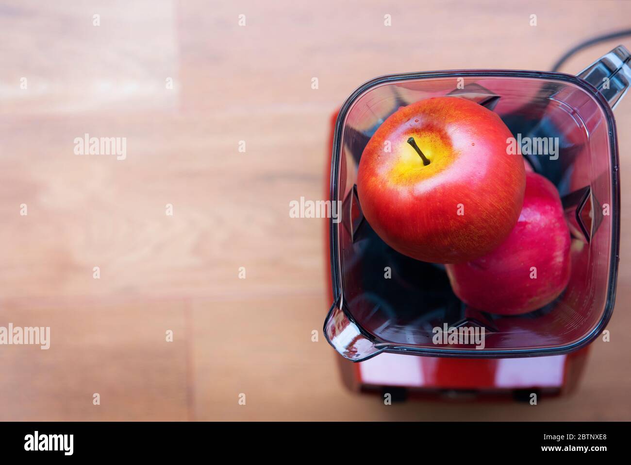 Fruit in a blender Red apple smoothie in a clear glass with copy space  Stock Photo - Alamy