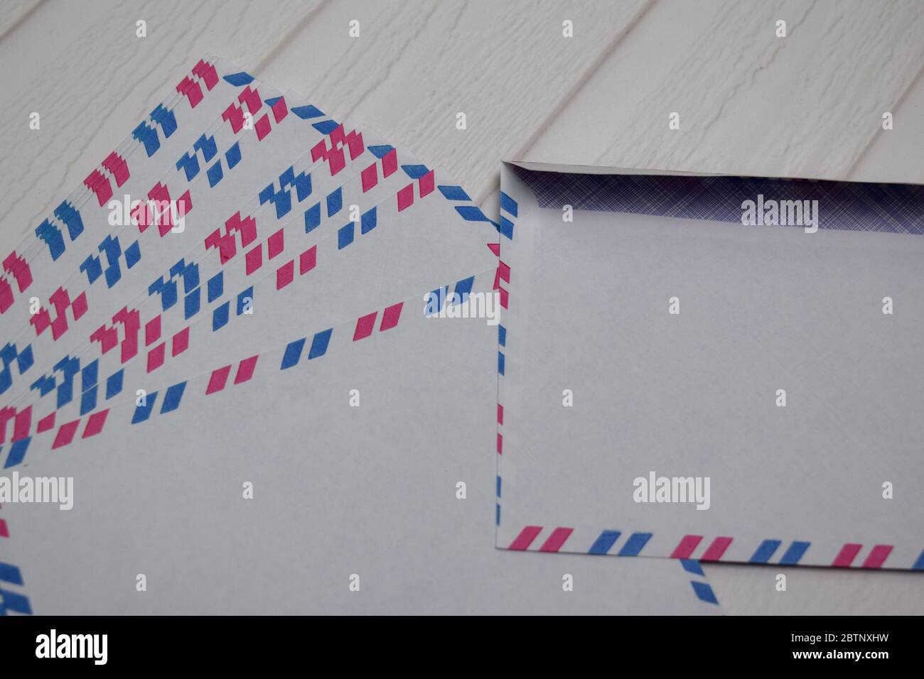Air Mail Envelope isolated on wooden table. Stock Photo