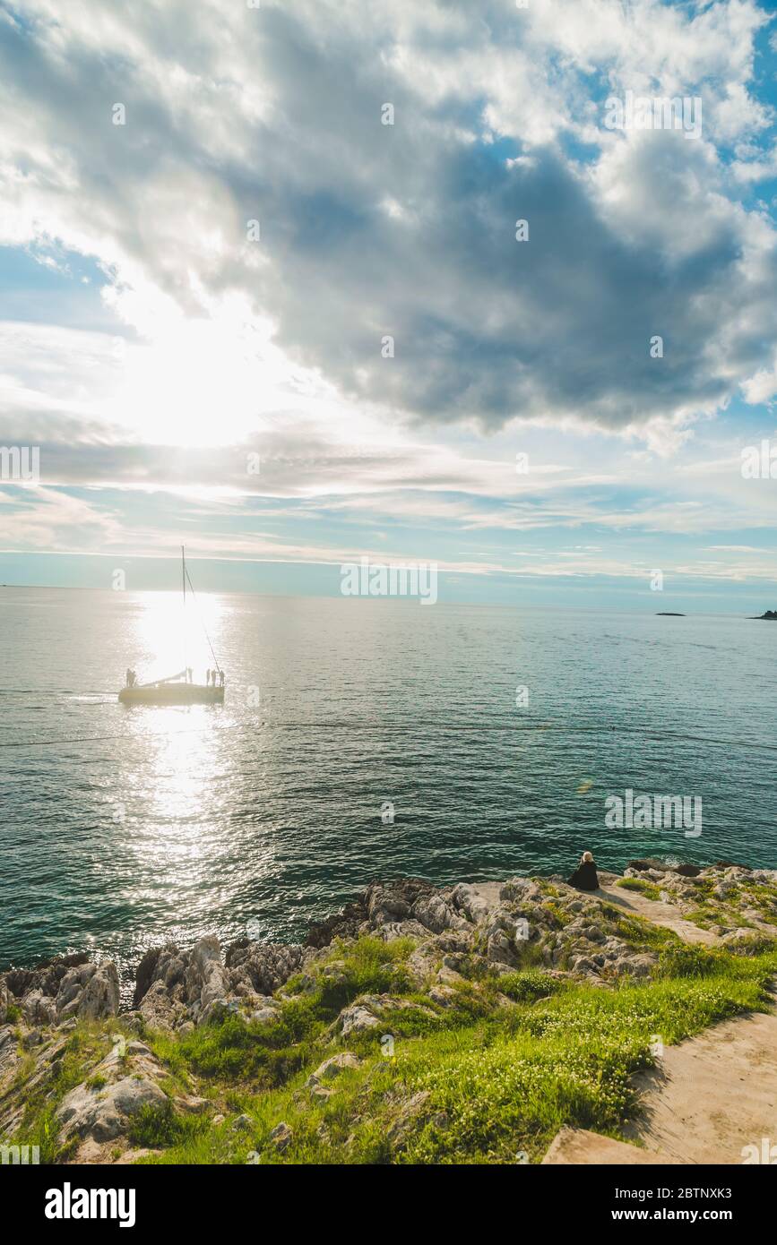 woman sitting at sea beach enjoying the beauty of sunset Stock Photo ...