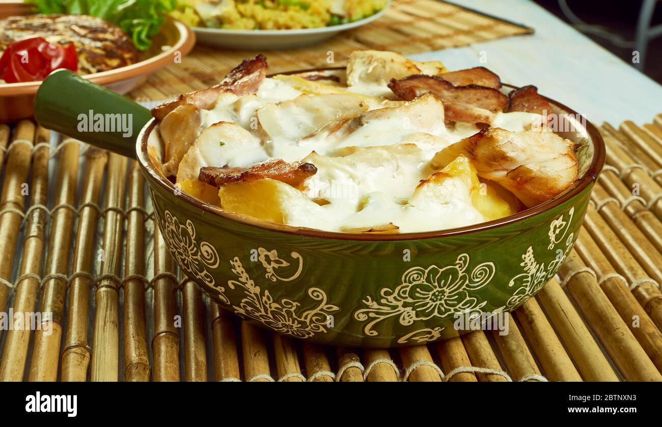 Smoked haddock savoy cabbage,bacon and creamy potato gratin Stock Photo
