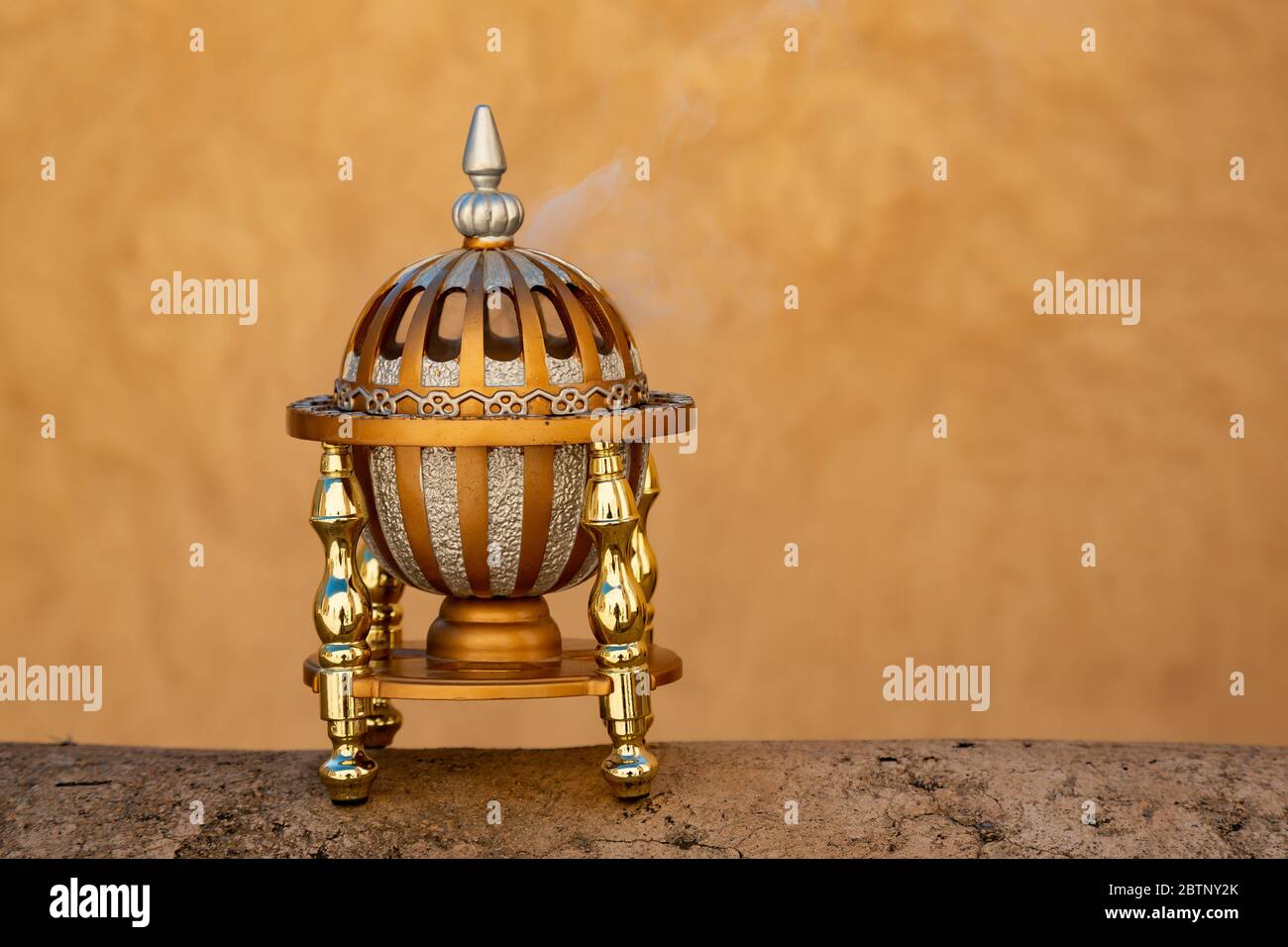 Omani incense burner sitting on a wall in Nizwa fort and steaming Stock