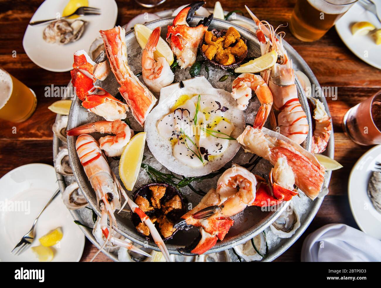Seafood feast featuring clams, oysters, and lobster rolls.