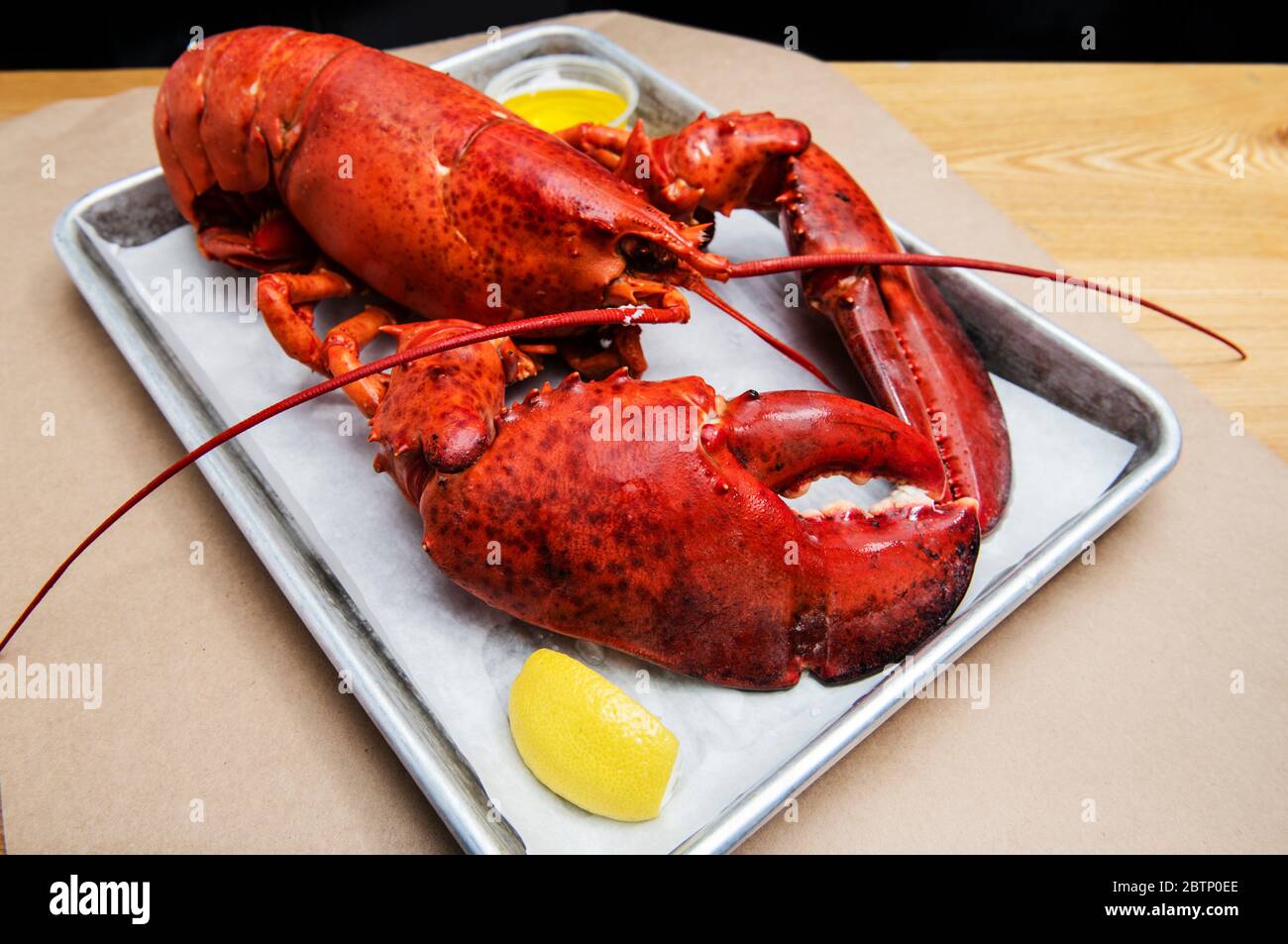 Whole Lobster with butter and lemon Stock Photo Alamy