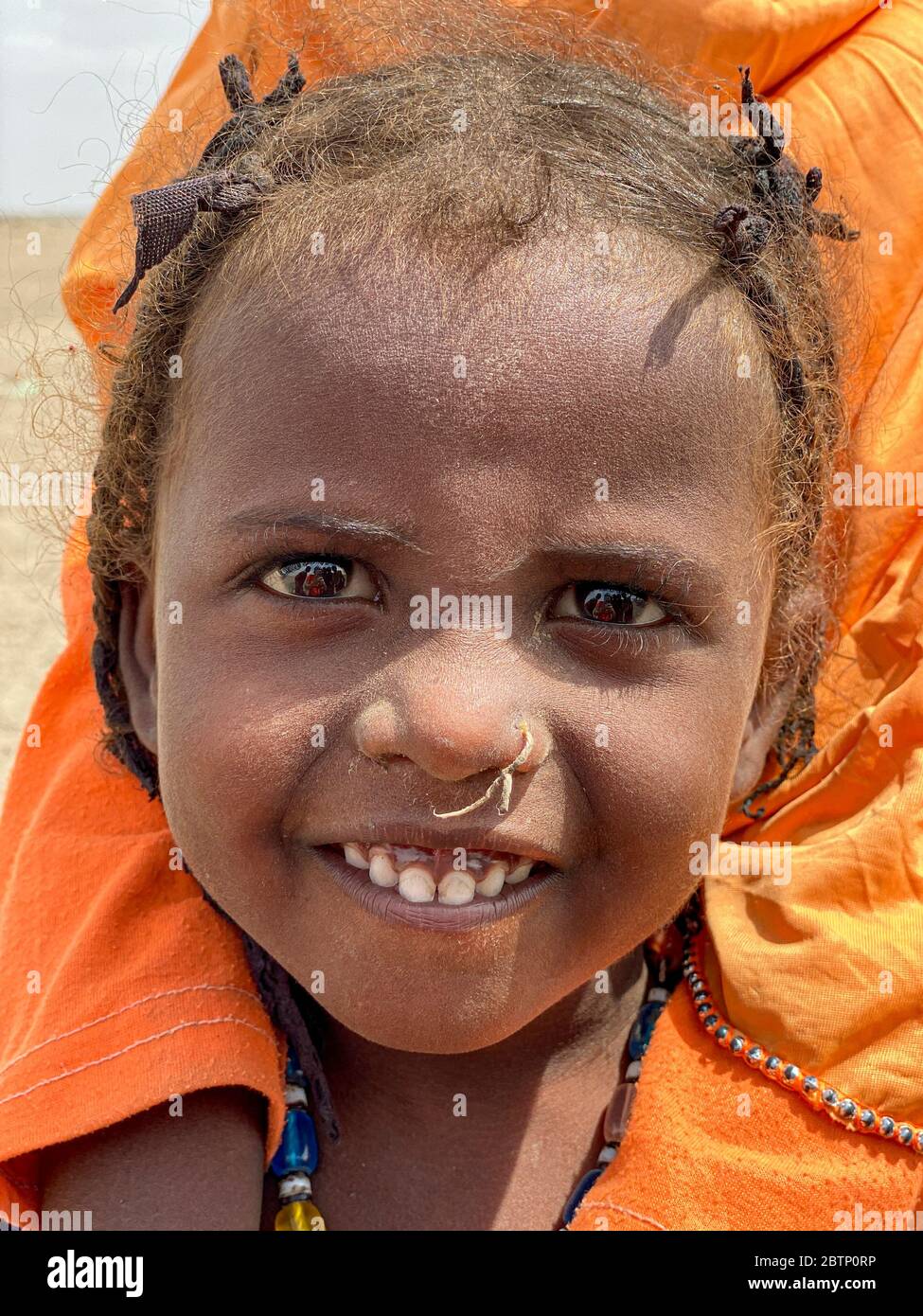 Portrait of smiling Afar little baby girl, Ethiopia, Africa Stock Photo