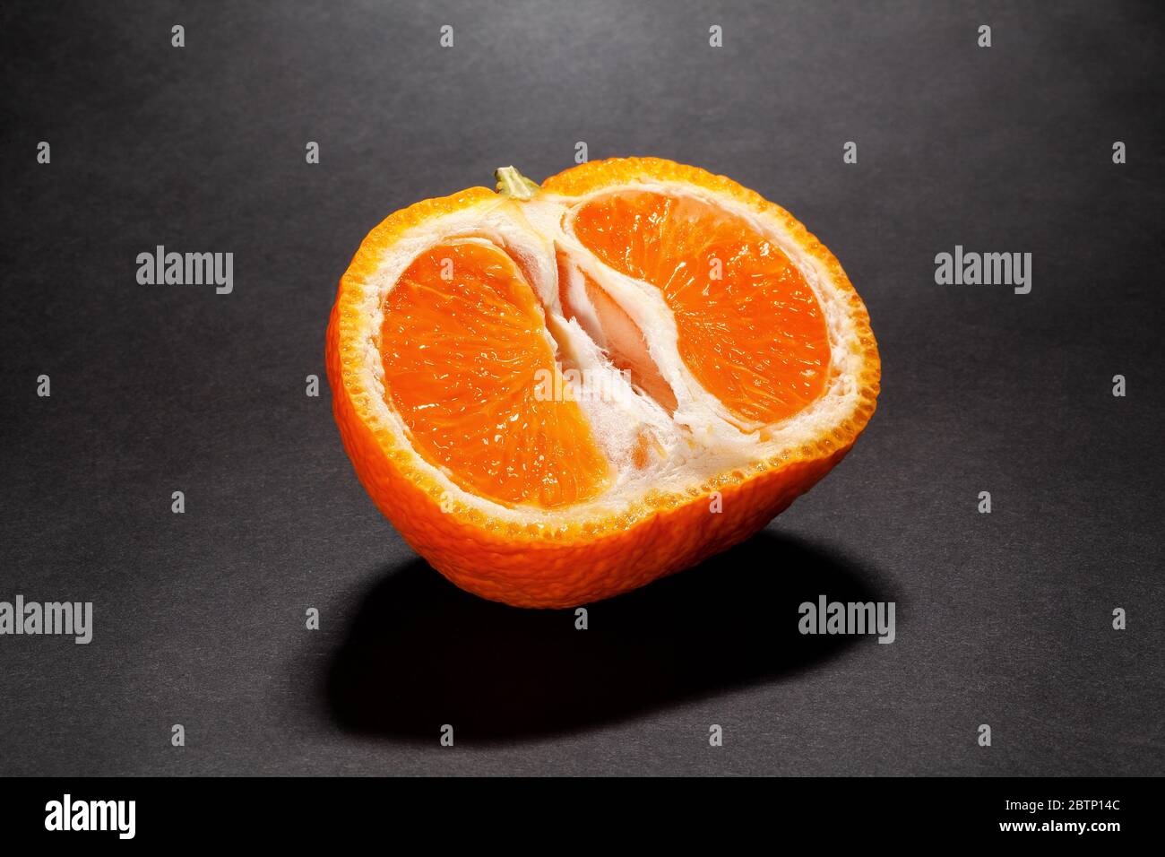 sliced tangerine on black background Stock Photo