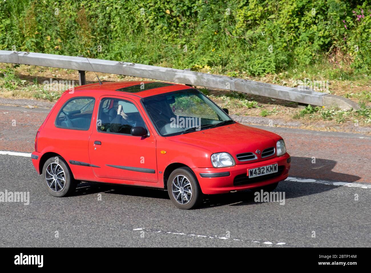 https://c8.alamy.com/comp/2BTP14M/2000-red-nissan-micra-celebration-16v-vehicular-traffic-moving-vehicles-cars-driving-vehicle-on-uk-roads-motors-motoring-on-the-m6-motorway-highway-2BTP14M.jpg