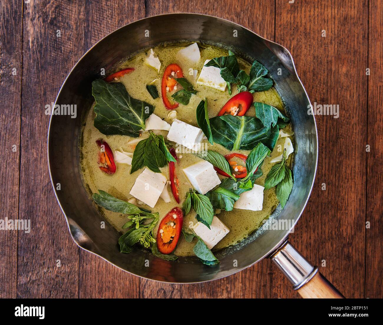 Thai green curry with tofu and vegetables being prepared Stock Photo ...