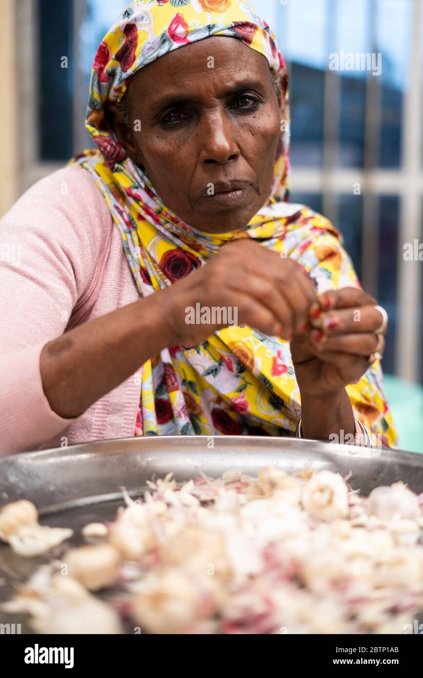 Portrait of muslim woman processing food in the market of Bati, Amhara Region, Oromia, Ethiopia, Africa Stock Photo