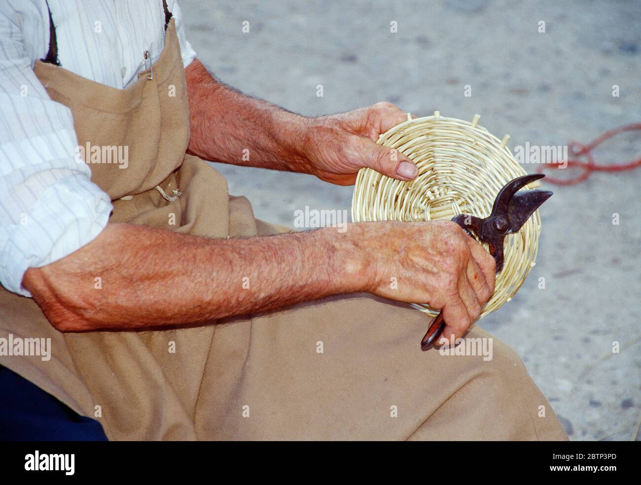 Old man making a wicker basket. Covarrubias, Burgos province, Castilla Leon, Spain. Stock Photo