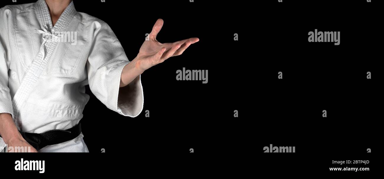 A person practicing aikido on a black background. Stock Photo