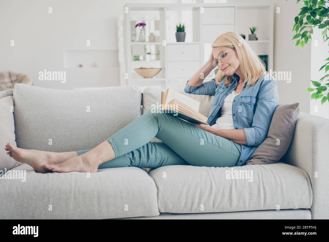 Profile Photo Of Attractive Aged Mature Homey Lady Sitting Comfy Sofa Couch Barefoot Reading Interesting Historic Novel Book Stay Home Quarantine Time Stock Photo Alamy
